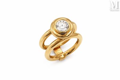 a close up of a gold ring with a diamond on it