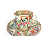 a cup and saucer on a saucer on a white surface