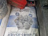 a bag of cement and a gas can in the back of a truck