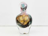a glass bottle with a gold heart inside of it