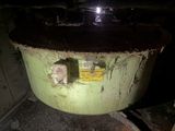 a large green pot sitting in the middle of a room