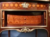 a wooden cabinet with a mirror on top of it