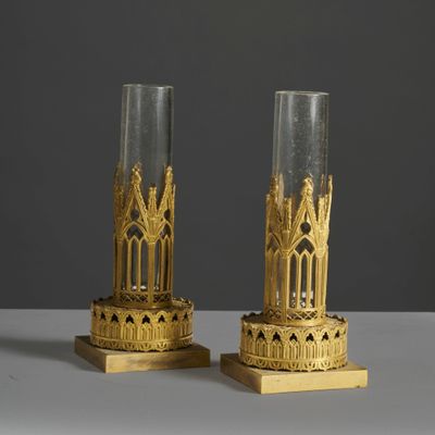 pair of gold - plated candlesticks with architectural design