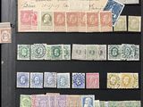 many different stamps on a black book on a table