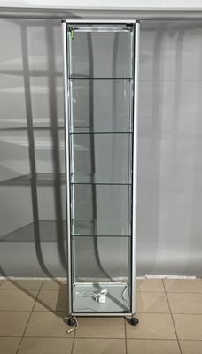 a glass display case in the corner of a room