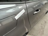 a car that has a sticker on the side of it ' s door