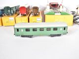 several toy trains are lined up in a row on a white surface