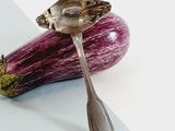 purple eggplant with a spoon and spoon rest on top of it