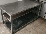 a kitchen with a table and a stove in it