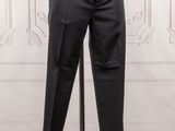 black pants on a mannequin stand in front of a white wall
