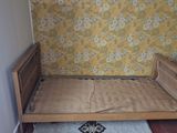 a bed that is in a room with a rug on the floor