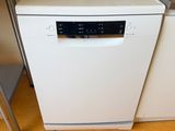a white dishwasher sitting in a kitchen next to a counter