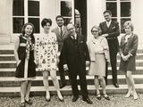 black and white photograph of a group of people standing outside a building