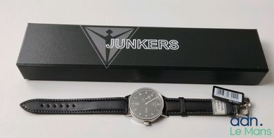 the watch is sitting on the box next to it ' s box