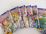 seven anime books are lined up on a white surface