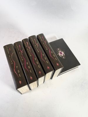 five books are stacked on top of each other on a white surface