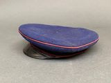 a blue cap with a red stripe on it
