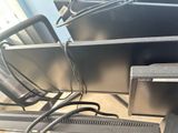 many computer monitors that are sitting on a table