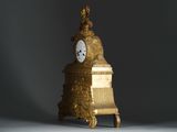 a gold clock sitting on top of a table