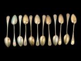 six silver spoons are arranged in a row on a black background