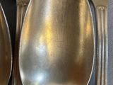 a lot of spoons that are sitting on a table