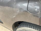 a close up of a car ' s tire with a hole in the side