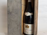 a bottle of wine in a wooden box on a table