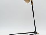 a black and gold lamp with a wooden base on a white background