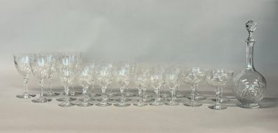 many wine glasses and a decanter on the table