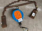 a blue and orange tape measure on a chain