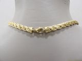 a close up of a gold chain on a mannequin