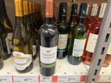 many bottles of wine on the shelves in the store