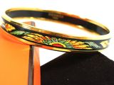 an image of a black and gold bracelet with sunflowers on it