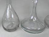 three glass vases sitting next to each other on a table