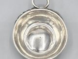 a close up of a silver metal object on a white surface