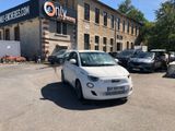 a small white car parked in front of a building