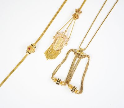 trois colliers en or et un collier orné d'un pendentif représentant un visage