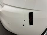 a close up of a white car with a sticker on it