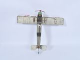 a small model of a small airplane on a white surface