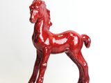 statue of a red horse on a white background