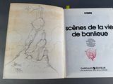 an open book with a drawing of a man sitting on a bench