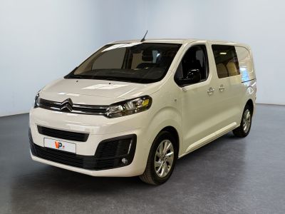 the white van is parked in a room with a gray floor