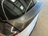 a close up of a car ' s rear end with a broken window