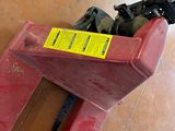 a red piece of equipment that is sitting on the floor