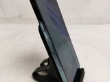 a close up of a cell phone on a stand on a table