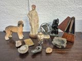 a wooden table topped with figurines and other items