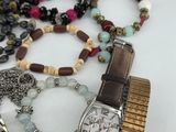 many different types of watches and bracelets on the table