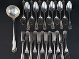 a lot of silver spoons and forks on the table