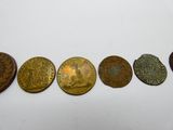 cinq types de pièces différents sont disposés en rangée sur une surface blanche