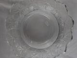 a clear glass plate with a flower design on it